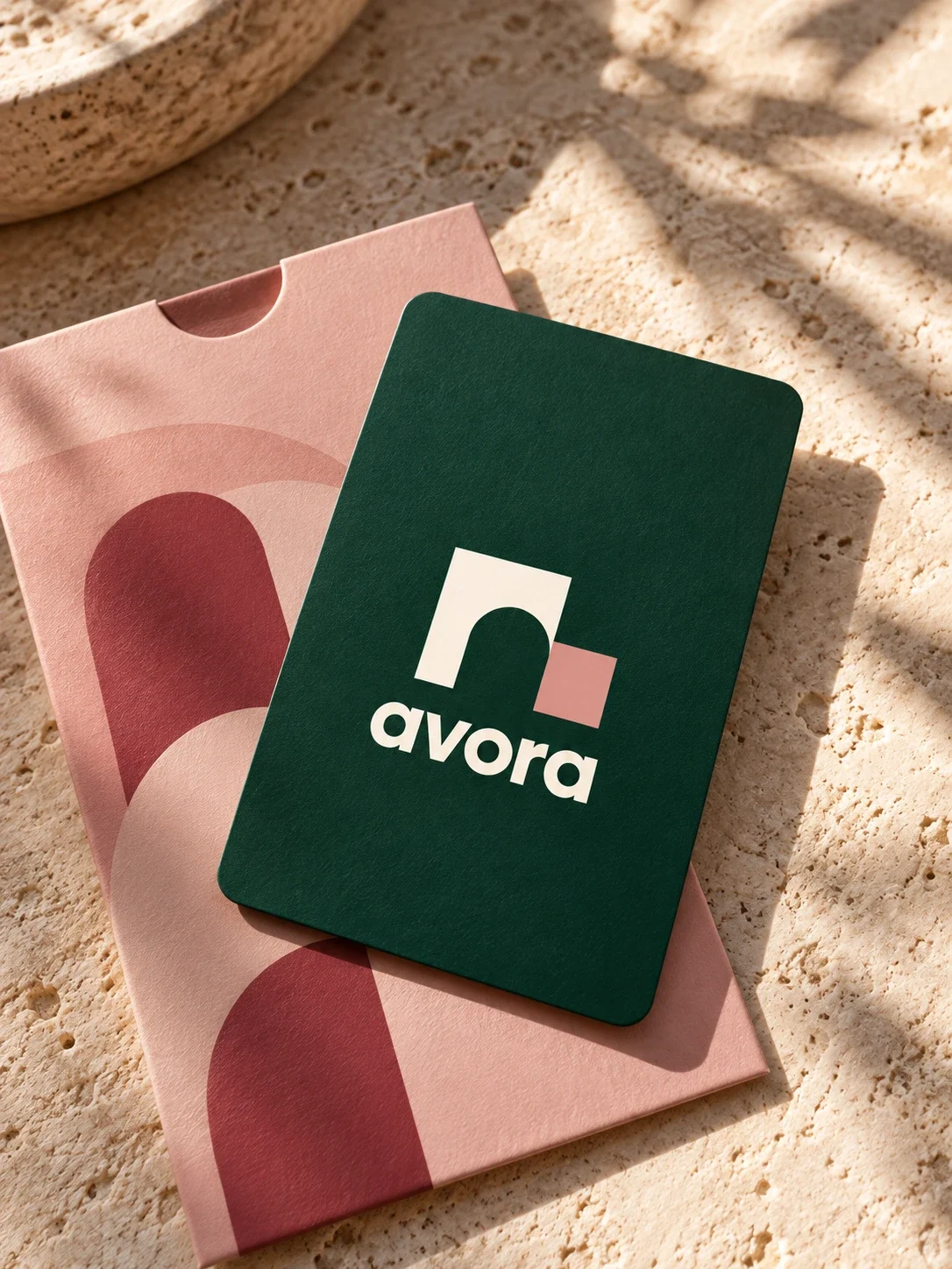 Avora green guest booklet over pink printed material.